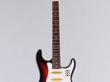 an electric guitar hanging from a string on a white wall