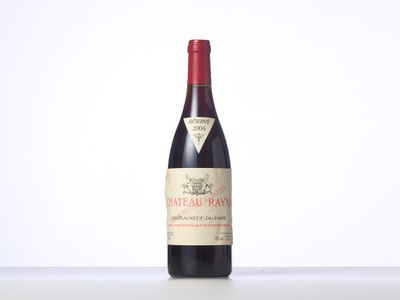 the bottle of red wine is sitting on the table