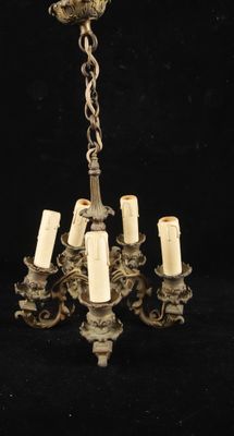 a chandelier that has five candles on it