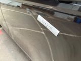 a sticker on the door of a car that is parked