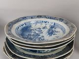 several blue and white plates are stacked on top of each other