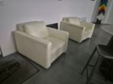 two chairs that are sitting in a room together