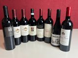 several bottles of wine are lined up on a table
