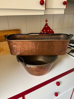 pots and pans sit on top of a stove in a kitchen