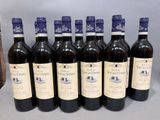 six bottles of wine are lined up in a row on a table