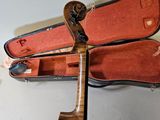 a violin and a violin case on a table