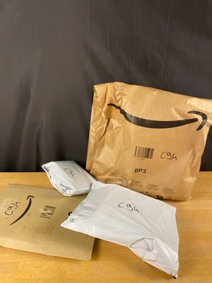 two bags of food sitting on a table next to a bag of food