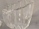 a clear glass vase and a small glass vase on a table