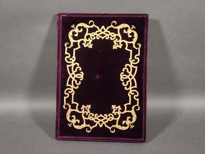 a purple and gold book with a gold border on it