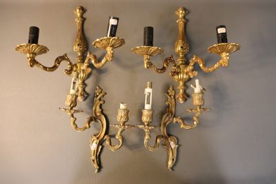 a wall mounted candle holder with three candles on it