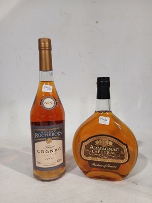 two bottles of brandy sitting next to each other on a white surface