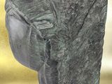 an image of a stone sculpture of a head on a table
