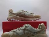 a pair of beige sneakers sitting on top of a red box