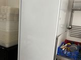 a refrigerator in a kitchen with a lot of dishes on the counter