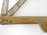 a close up of a metal object on a white surface