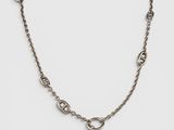 a close up of a chain with a cross on it