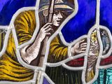 a stained glass window with a man holding a fish