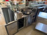 stainless steel counter top with a pan on it in a restaurant