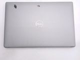 dell laptop computer sitting on top of a table with a white background