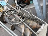 an image of a bunch of pipes and wires sitting on the ground