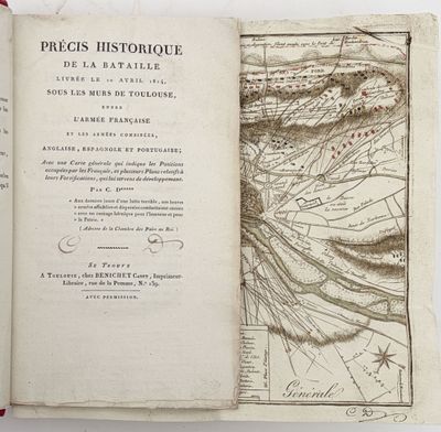an open book with a map on it sitting on top of a table