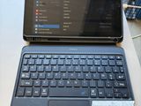 a laptop and a tablet on a table with a price tag on it