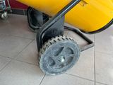 a yellow cement mixer sitting on top of a tile floor
