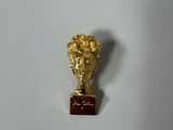 a gold statue of a man with a plaque on it