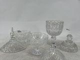 several pieces of glass sitting on top of a table next to each other