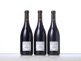three bottles of wine sitting on top of a table next to each other