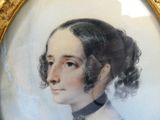 portrait d'une femme en robe bleue avec un nœud papillon noir