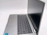 a silver laptop computer sitting on top of a white table
