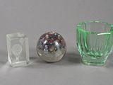 two glass vases and a glass ball on a table