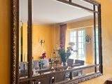 un miroir accroché au mur au-dessus d'une table dans une pièce