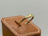 pair of wedding rings in a wooden box on a white background
