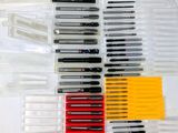 a lot of pens that are sitting on a table