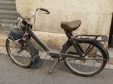 a old bicycle parked on the side of the street