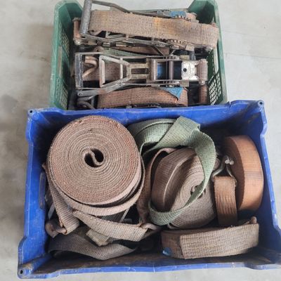 a blue box filled with a bunch of different types of belts