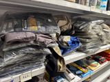 many bags of clothing on the shelves in the store