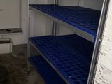 a room with bunk beds and a fan in it