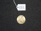 a small gold coin with a price tag on it