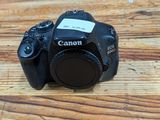 a canon camera sitting on a wooden table
