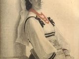 portrait of a woman in a sailor ' s outfit with a red ribbon around her neck