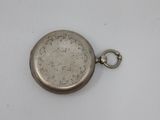 a silver pocket watch with a chain on a white surface