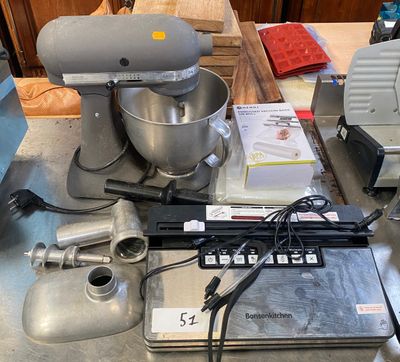 a picture of a kitchen counter with a mixer and a laptop