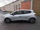 a small silver car parked on the side of the road