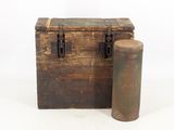 an old wooden chest and a metal cylinder on a white background