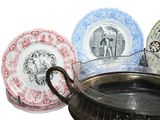 three plates with pictures on them sitting next to each other
