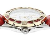 a close up of a wrist watch with a red strap