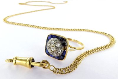 an image of a gold chain with a blue and white diamond ring and a gold chain with a blue and white diamond ring and a gold chain with a blue and